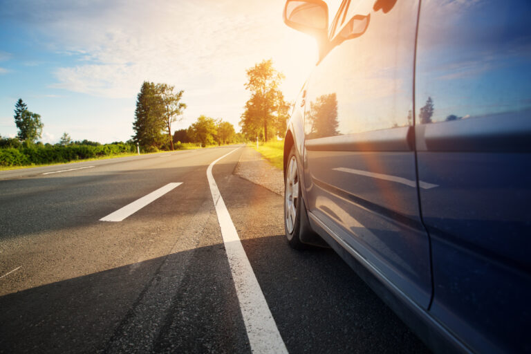 Car on asphalt road emphasizing road safety.