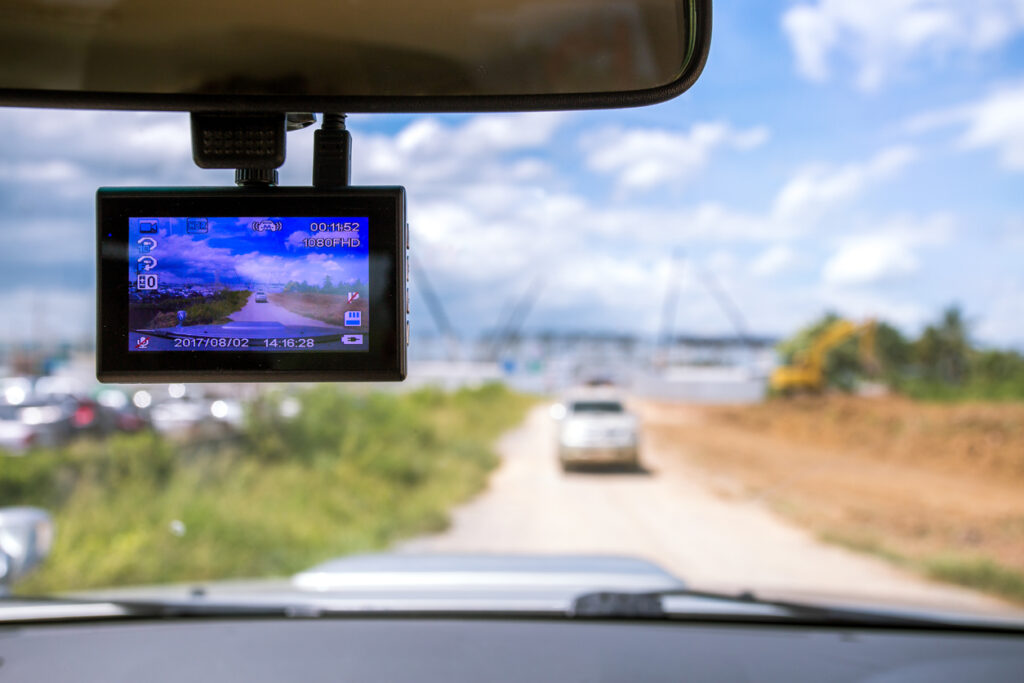 Dash camera recording in a car while on the road.