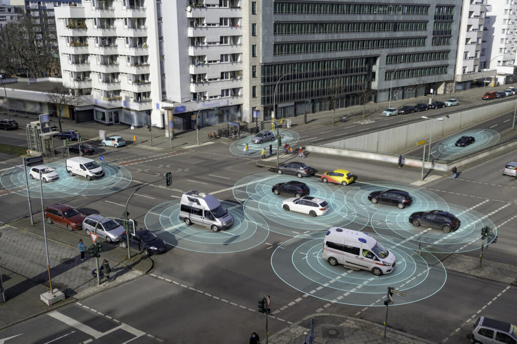 Cars using radar sensors on a busy street.
