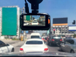 Dashcam in a vehicle recording cards on the road.