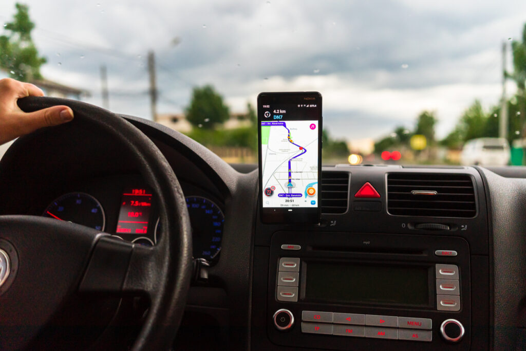 Smartphone with Waze map in a car.