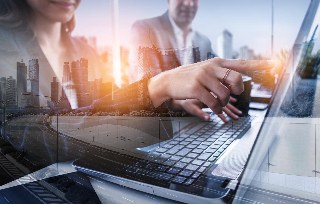 AI for Infrastructure Equity: Digital composite image of a man and a woman working on a laptop.