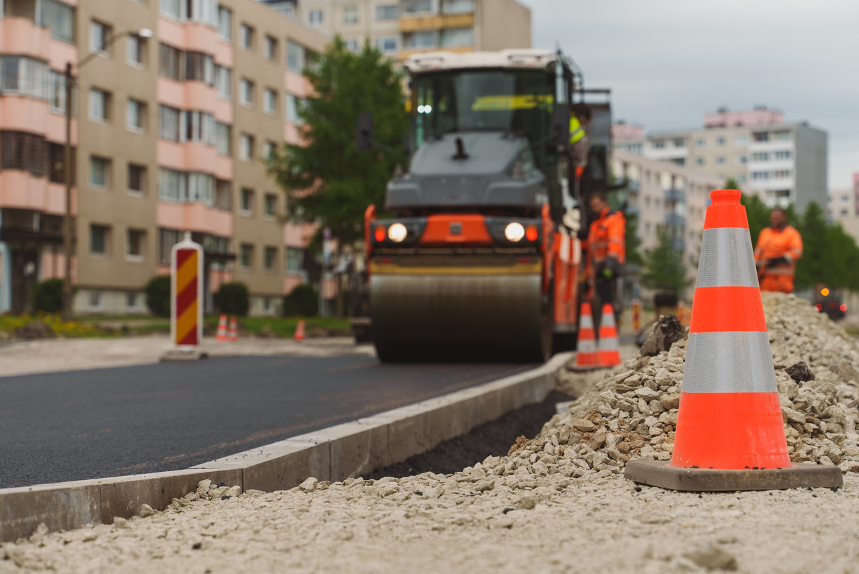 Google Street View: A heavy vibration roller stacking hot asphalt during road construction.