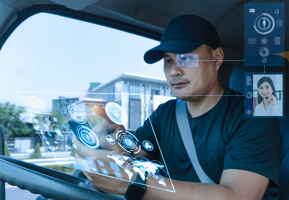 Mobile sensor network - an Asian male truck driver accessing his smartphone inside a truck.
