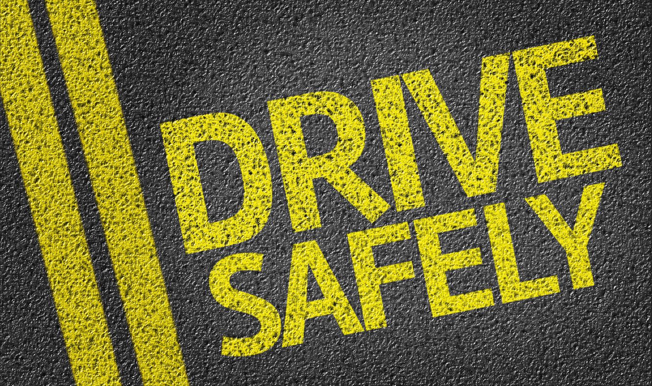 Safer roads for cyclists and motorists - a picture of a paved road with text “Drive safely”.